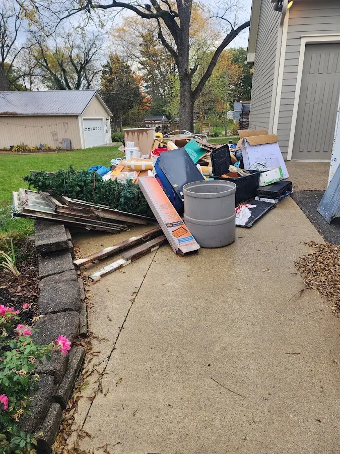 Dumpster being loaded with debris for Estate Cleanout Dumpster Rental in Belgrade